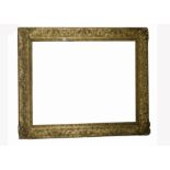 A large late 19th/early 20th Century gilt wood picture frame, of rectangular form with scrolling