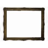 A large late 19th/early 20th Century gilt frame, wooden structure with gesso mouldings of stylised