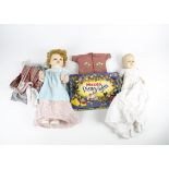 A selection of 20th Century toys, including two dolls together accompanied by a red suitcase