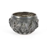 An Indian silver bowl, with hammered figural decoration of figures engaged in revelry or conflict