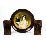 A Japanese ivory and lacquered wood charger, with central figure of a Geisha holding a mirrored