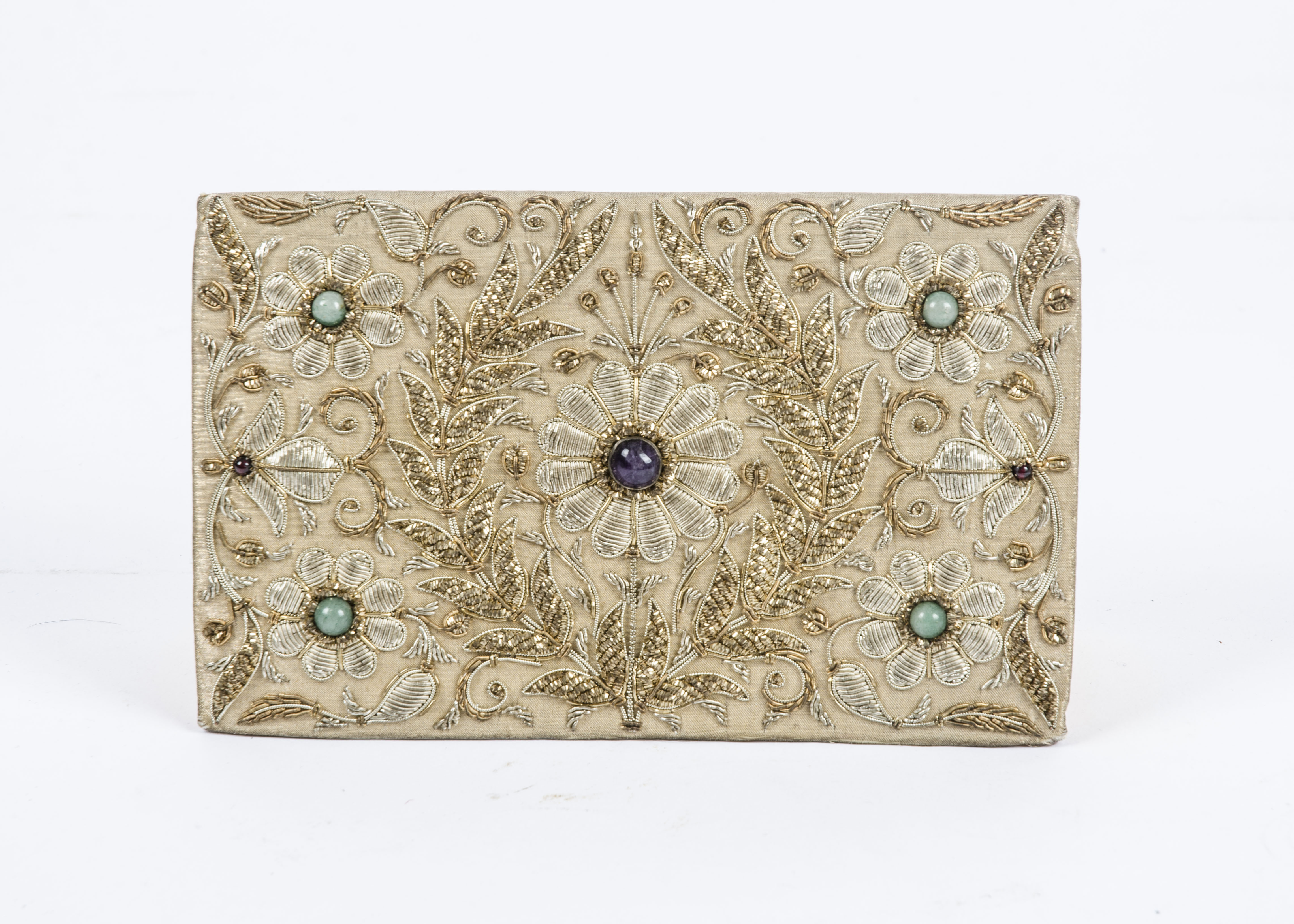 A vintage purse or clutch bag with semi precious stones, and gilt raised decoration, and interior