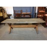 A large rectangular oak garden table, with X stretcher, 91cm x 244cm x 77cm high