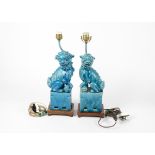 A pair of 17th Century style Chinese Kylin or Dogs of Fo, the porcelain with turquoise glaze,