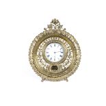 A 19th Century brass strut clock, with enamelled dial and roman numerals and highly ornate surround,