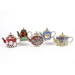 A collection of Trade Aid teapots with hand painted enamel decoration, each individual piece