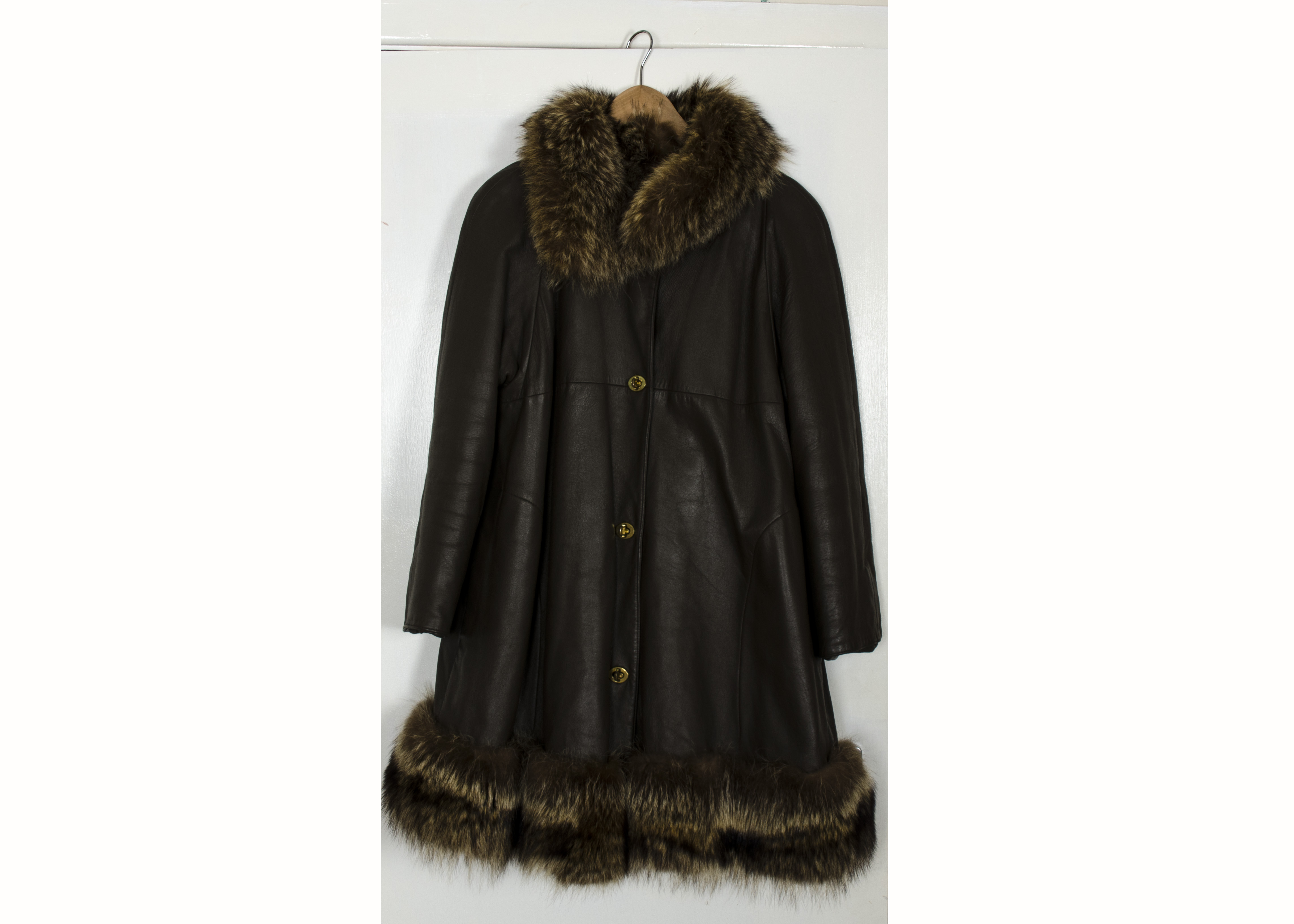 A Vintage brown leather coat, swing' style, with a fox fur collar and hem and a brown faux fur