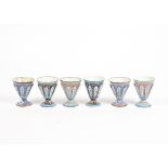 Six metal goblets with enamel decoration, likely of Eastern origin, each vessel with raised panels