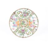 A Chinese canton famille rose export plate, the central roundel with a parrot amidst foliage,
