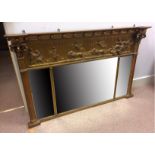 An antique three-section gilded over mantle mirror, the upper section with a classical scene