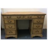 A 19th Century painted pine kneehole desk, two long drawers over three short graduated drawers to