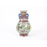 A Chinese twin handled vase decorated in polychrome enamels, with figural handles, a central ruyi