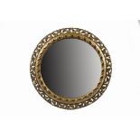 A giltwood and gesso convex mirror, the moulded frame with scrolling decorations and wreaths,