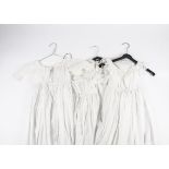 A quantity of Victorian and later christening gowns, decorated with lacework, whitework and