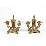 A pair of ormolu twin branch candelabra, in the neo-classical taste with four scrolling feet, height
