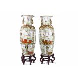 A pair of Chinese vases of substantial proportions on hardwood stands, the vases have multilobed