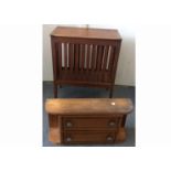 A continental antique pine storage cabinet, with slatted sides and a hinged lid, raised on tapered