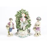 Three late 18th or early 19th Century European porcelain figures, one a child holding picked