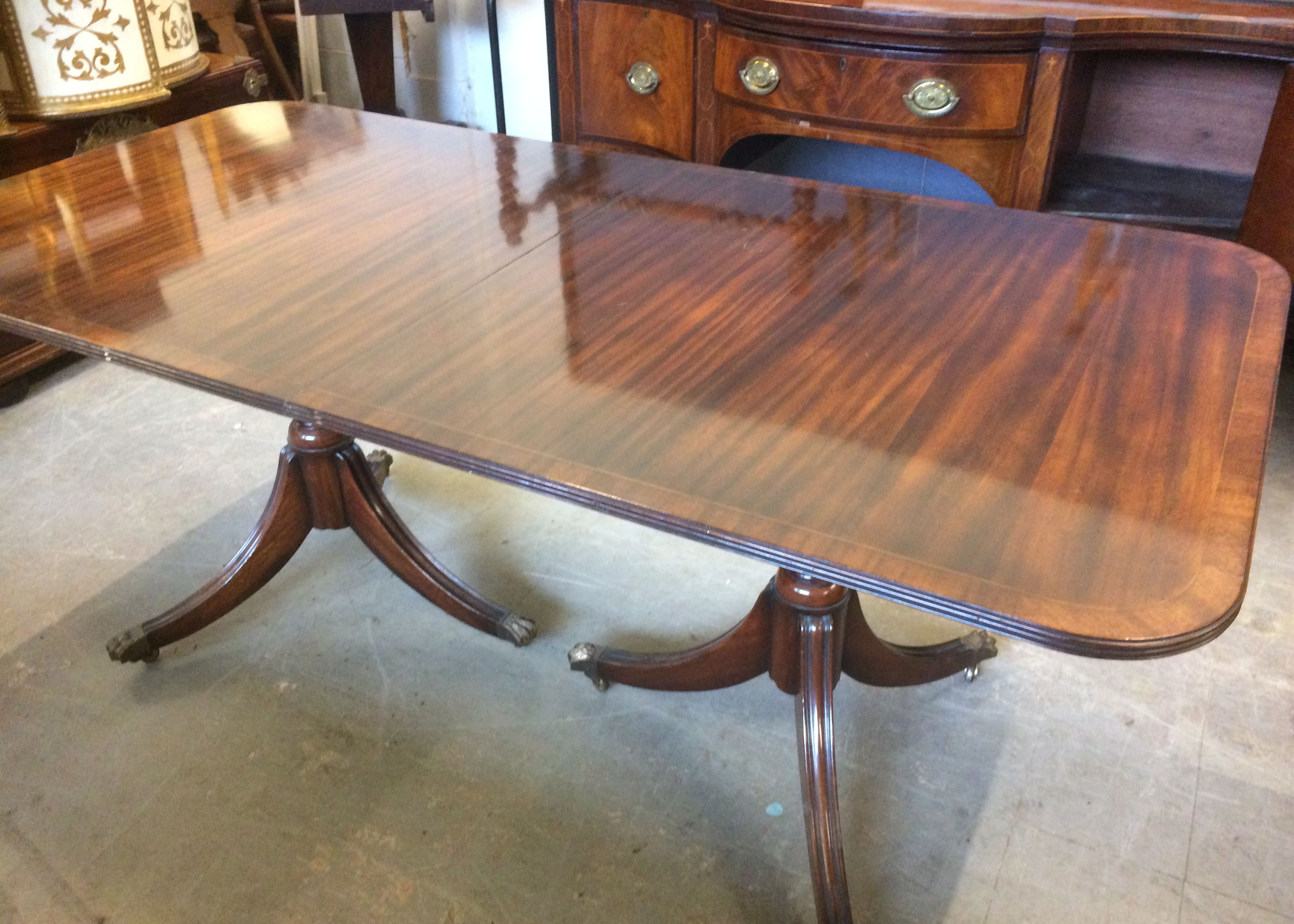 A Regency style mahogany twin pedestal dining table, with extra leaf, impressed 2761 to underside, - Image 2 of 3