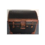 An Early 20th Century travelling trunk, domed structure with leather bindings, lined with an