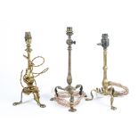 Three early 20th Century brass lamp bases, on three footed bases, converted to electric, height (