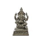 A cast bronzed brass figure of Indian deity Ganesh, he is sitting above multiple small figures