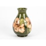 A William Moorcroft pear shaped vase, tube lined and decorated in the 'Hibiscus' pattern against a