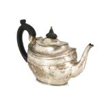 An Edwardian silver teapot, possibly by GM, oval with engraving and applied black handle and finial,