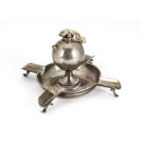 An Edwardian silver cigar holder table lighter from Goldsmiths & Silversmiths, circular with four