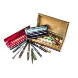 A small collection of fountain pens and pencils, including a Victorian silver pencil in fitted
