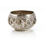 An early 20th century Indian silver bowl, circular Burmese style with ornate embossed figures and