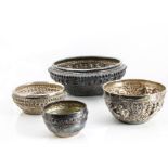 Four late 19th and early 20th century Indian and Middle Eastern white metal bowls, all circular of