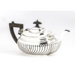 An early George V silver teapot, fluted lower, applied handle and finial, marked Chester 1911,