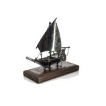 A vintage Middle Eastern white metal model of a dhow, the Arabian boat on wooden stand, 19cm, AF