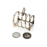 An Art Deco period silver toast rack by EV, together with a 1797 cartwheel two penny, VF-EF, and