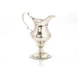 A George III silver cream jug by CH, London 1787, helmet shaped on socle base, possibly repaired