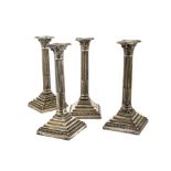 A set of four George V silver filled candlesticks by HE Ltd, AF, each Corinthian style fluted column