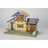 An unusual German red roof dolls’ house border control, possibly Gottschalk with central office with