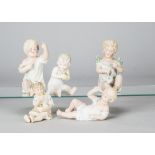 Five German bisque babies, one seated with an apple —5in. (12.5cm.) high, another holding a shoe and