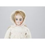 A German shoulder head doll, with fixed blue glass eyes, closed mouth, solid domed pate, turned