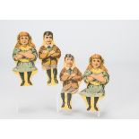 Four toy seated wooden children, printed colour paper applied to wood, two Edwardian boys and two