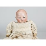 A Schoenau & Hoffmeister character baby, with fixed blue glass eyes, closed down turned mouth,