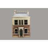 A painted wooden dolls’ house, the painted stone and brick facade with central dummy front door with