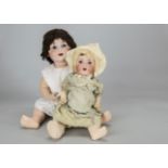 Two Armand Marseille character babies, a large 980 with blue sleeping eyes, synthetic brown wig