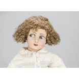 A continental felt girl doll, with pressed face with large brown side glancing eyes, brown curly