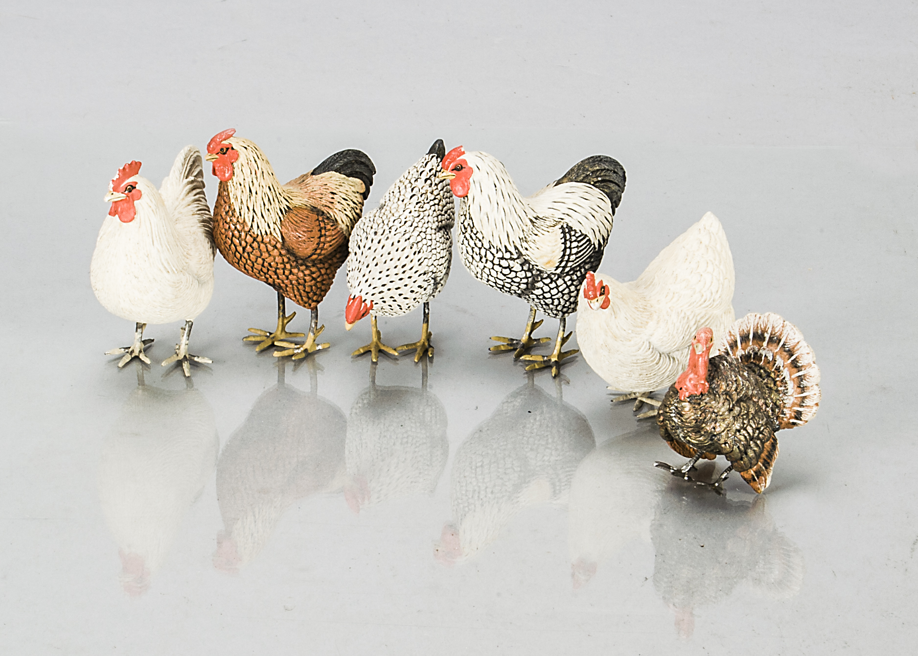 Five German composition chickens, with metal feet —3in. (8cm.) high; and a turkey