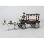 An unusual folk art model or toy of a horse-drawn hearse, painted wood with grey horse, coffin and