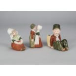 Gebruder Heubach Dutch children, a kissing couple —5in. (12.5cm.) high; a seated boy with basket