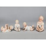 Four Gebruder Heubach babies, two seated, one high coloured —6in. (15cm.) high; one lying on back