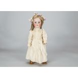 A Simon & Halbig 1299 child doll, with blue sleeping eyes, blonde hair wig, pierced ears, jointed